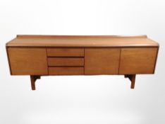 A 20th-century White & Newton teak low sideboard,