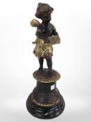A 19th-century patinated bronze figure of a cherub on socle, height 26cm.
