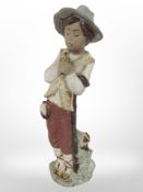 A Nao bisque figure of a boy holding a bird, height 28cm.