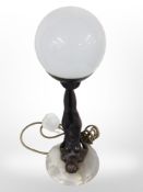 An Art Deco-style resin and onyx table lamp with opaque glass shade, height 44cm.