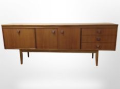 A 20th-century teak low sideboard fitted cupboards and drawers, 198cm long, 46cm deep x 75cm high.
