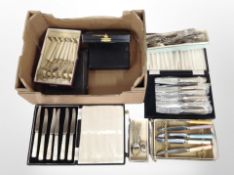 Several boxed sets of cutlery.