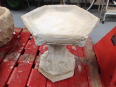 A concrete hexagonal birdbath, height 42cm.