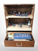 A wooden toolbox containing router parts.