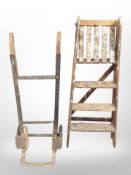 An antique sack barrow and a pine step ladder.