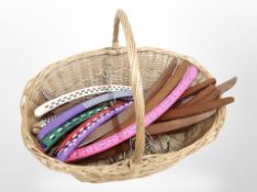 A wicker basket of 20th century Scandinavian teak coat hangers and other examples