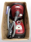 A Philips vacuum and a Nilfisk vacuum (continental plugs).