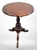 A reproduction carved mahogany tripod table in the Georgian style,