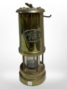 A Welsh brass miner's lamp.