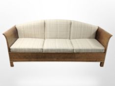 An 20th century Scandinavian satin birch three-seater bed settee,