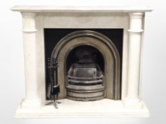 A marble twin-pillar fire surround with cast-iron insert and a companion stand,