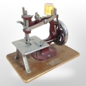 A vintage child's hand sewing machine.