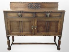 An Edwardian carved oak sideboard, 136cm wide x 51cm deep x 112cm high.