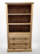 A contemporary pine open bookcase fitted drawers beneath, 82cm wide x 48cm deep x 153cm high.