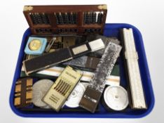 An abacus, together with a group of slide rules, a bridge counter,
