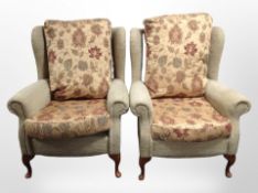 A pair of modern wingback armchairs.