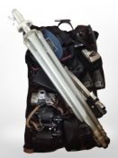 A group of digital cameras, pair of 8x30 binoculars, camera tripods, sunglasses, walkie-talkies,