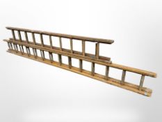 Two wooden extension ladders