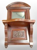 An Edwardian carved mahogany wall shelf, with mirror back, width 38cm.