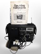 A Panasonic DR29 radio and a pair of headphones.