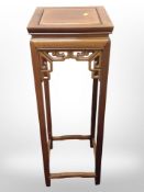 A contemporary oriental hardwood plant stand, height 92cm,