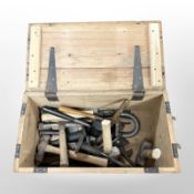 A vintage pine lidded crate containing assorted mallets and hammers, chisels, etc.