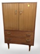 A 20th-century teak double-door linen cupboard fitted two drawers beneath,