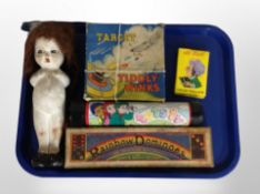 An antique chalk doll, together with a group of vintage games including Rainbow Dominoes,