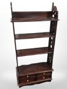 A reproduction four tier bookshelf fitted drawers beneath,