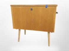 A 20th-century Scandinavian workbox on tapered legs.