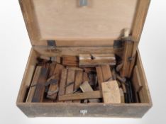 A vintage joiner's toolbox and contents to include wooden woodworking planes, mallet, etc.