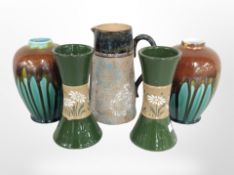 A pair of Royal Doulton vases and three further pieces of Doulton Lambeth pottery, tallest 17cm.