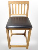 A contemporary oak bar chair.