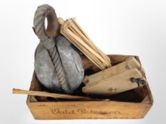 A vintage Danish pine crate containing a 19th century ship's pulley,