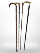 Four Victorian walking sticks, three with silver mounts.