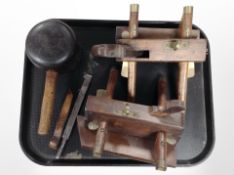 A vintage wooden mallet, together with two wooden and brass plough planes,
