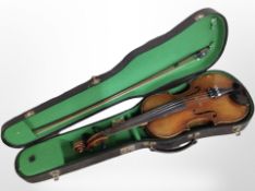 An early-20th century violin with two-piece 14-inch back, in coffin case with bow.
