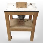 A pine and MDF joiner's two-tier trolley on wheels, 72cm wide x 56cm deep x 97cm high.