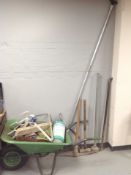 A wheelbarrow containing tools, garden sprayer, sieve, vice, together with a large crowbar, pickaxe,