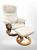 A contemporary cream leather swivel armchair with matching footstool.