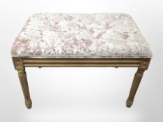 A contemporary rectangular footstool in pink plush fabric, width 66cm.