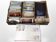 A collection of colour postcards, album of stamps, etc.