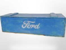 A vintage painted pine crate marked Ford containing assorted items including decorative hand axe,