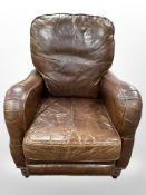 A contemporary chestnut-brown studded leather manual reclining armchair,