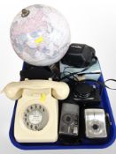 A vintage cream plastic telephone,