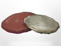 A silver compact in leather case,