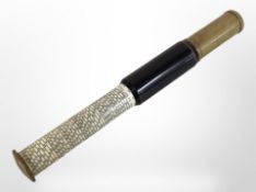 An early-20th century lacquered brass telescopic slide rule.