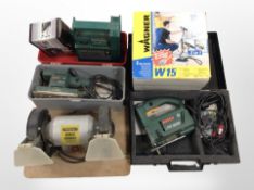 A group of power tools including Bosch jigsaw and sander, battery charger, tyre inflater,