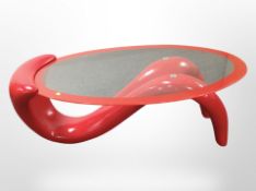A contemporary glass and fibre glass oval coffee table, length 122cm.