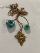 A polished blue quartz heart pendant on chain, a turquoise doughnut-shaped pendant on silver chain,